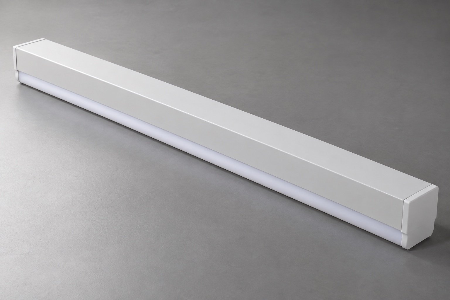 Illustrative closed steel housing of a commercial linear strip luminaire.
