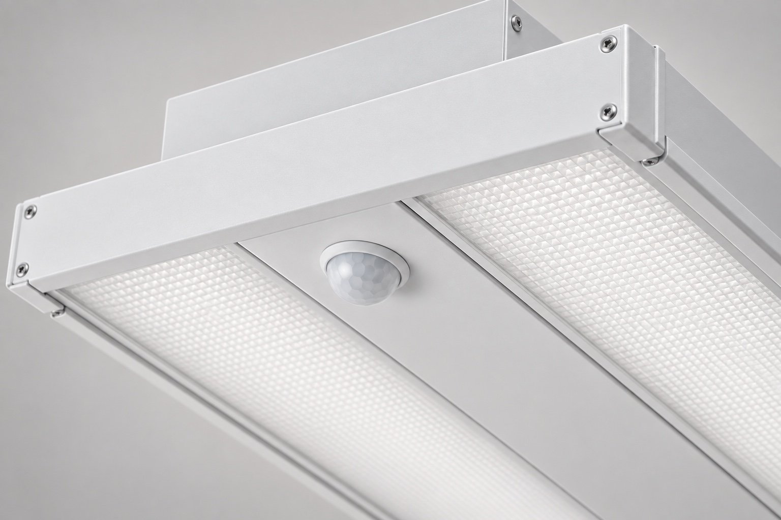 Illustrative close-up of an occupancy sensor on a linear high bay.