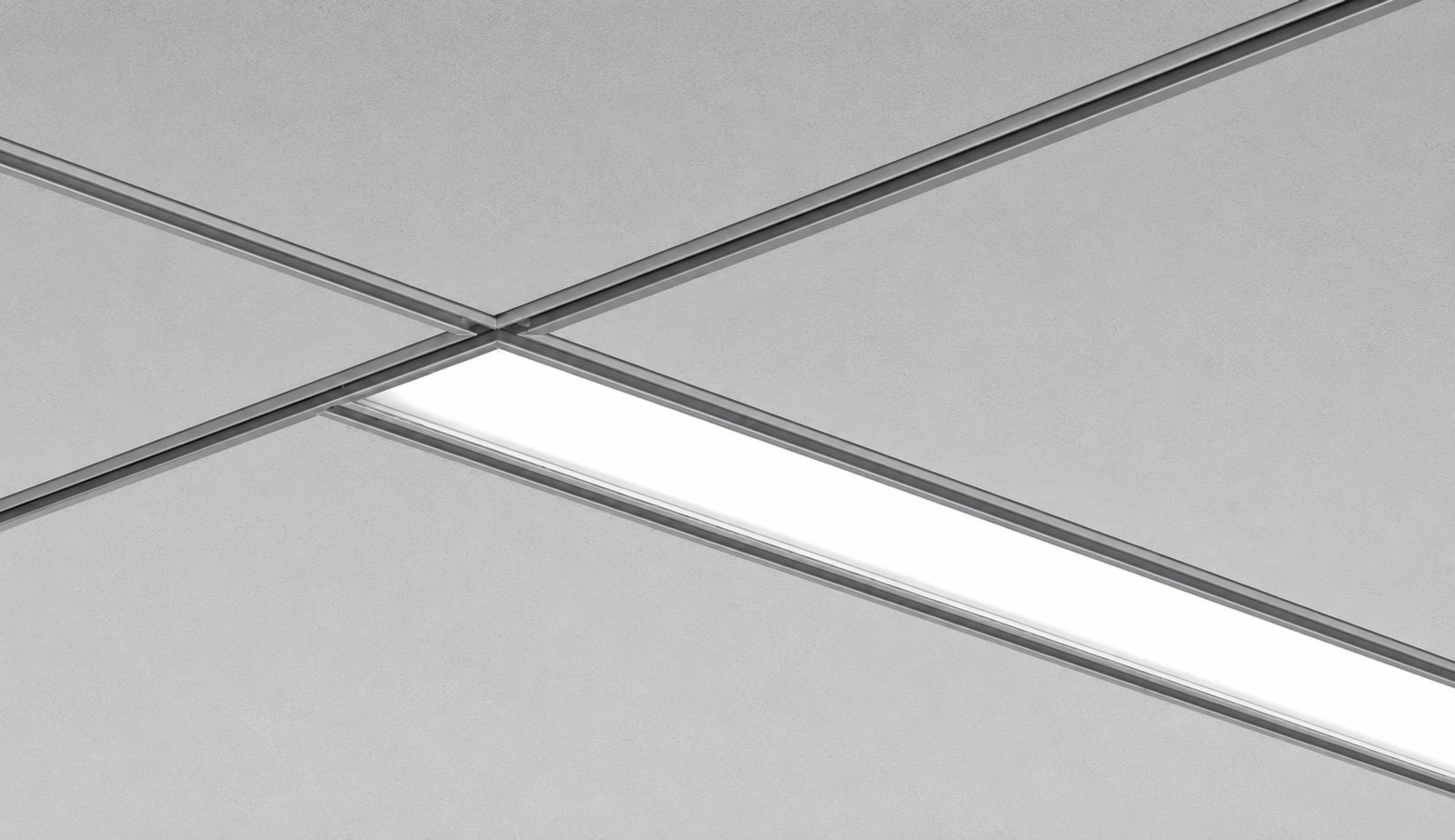 AM20G recessed LED luminaire integrated into a T-grid ceiling with illuminated linear diffuser